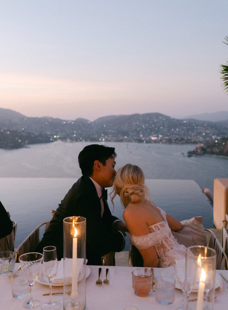 Bride and groom enjoying the view while dining at their wedding in Casa Angelina