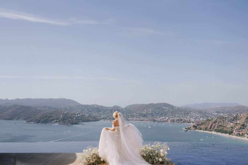 Bride in front of the beach showing off her dress